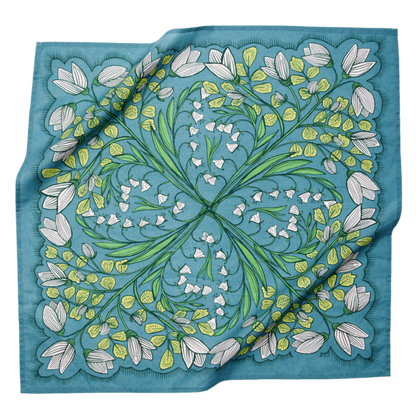 Cassie bandana in teal floral multi shown draped flat, featuring white flowers, green botanical details, and a square cotton design.