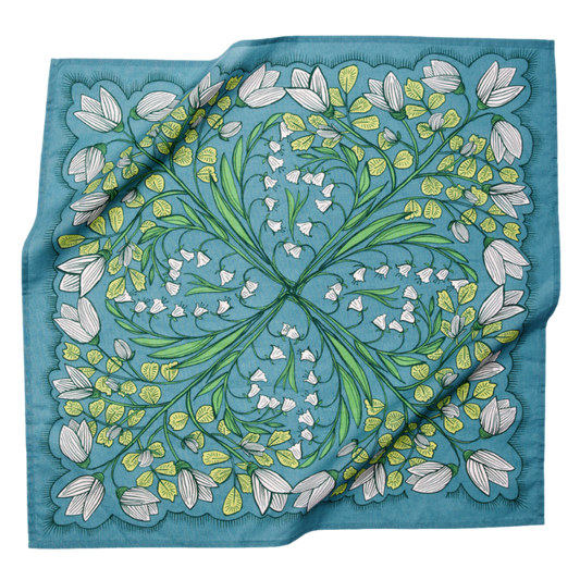 Cassie bandana in teal floral multi shown draped flat, featuring white flowers, green botanical details, and a square cotton design.