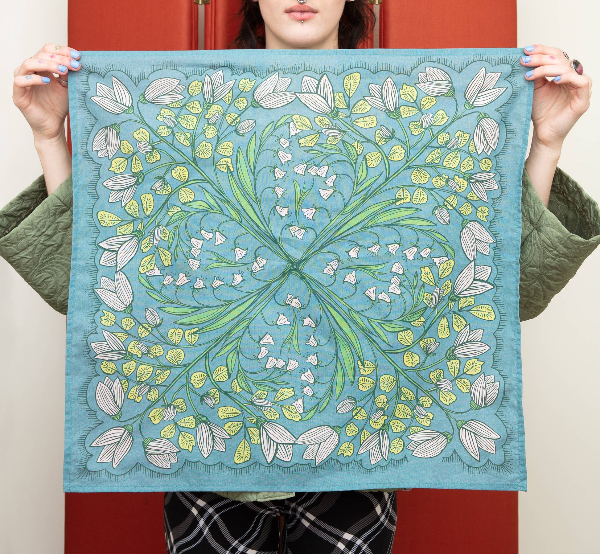 Full view of the Cassie bandana in teal floral multi, featuring white flowers, green leafy details, and a decorative botanical border.