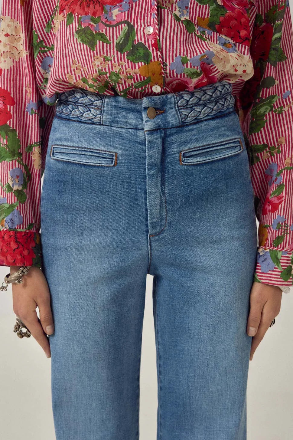 Close-up of the Cher Pant in Braid Denim highlighting the braided waistband detail, front button closure, and structured denim texture.