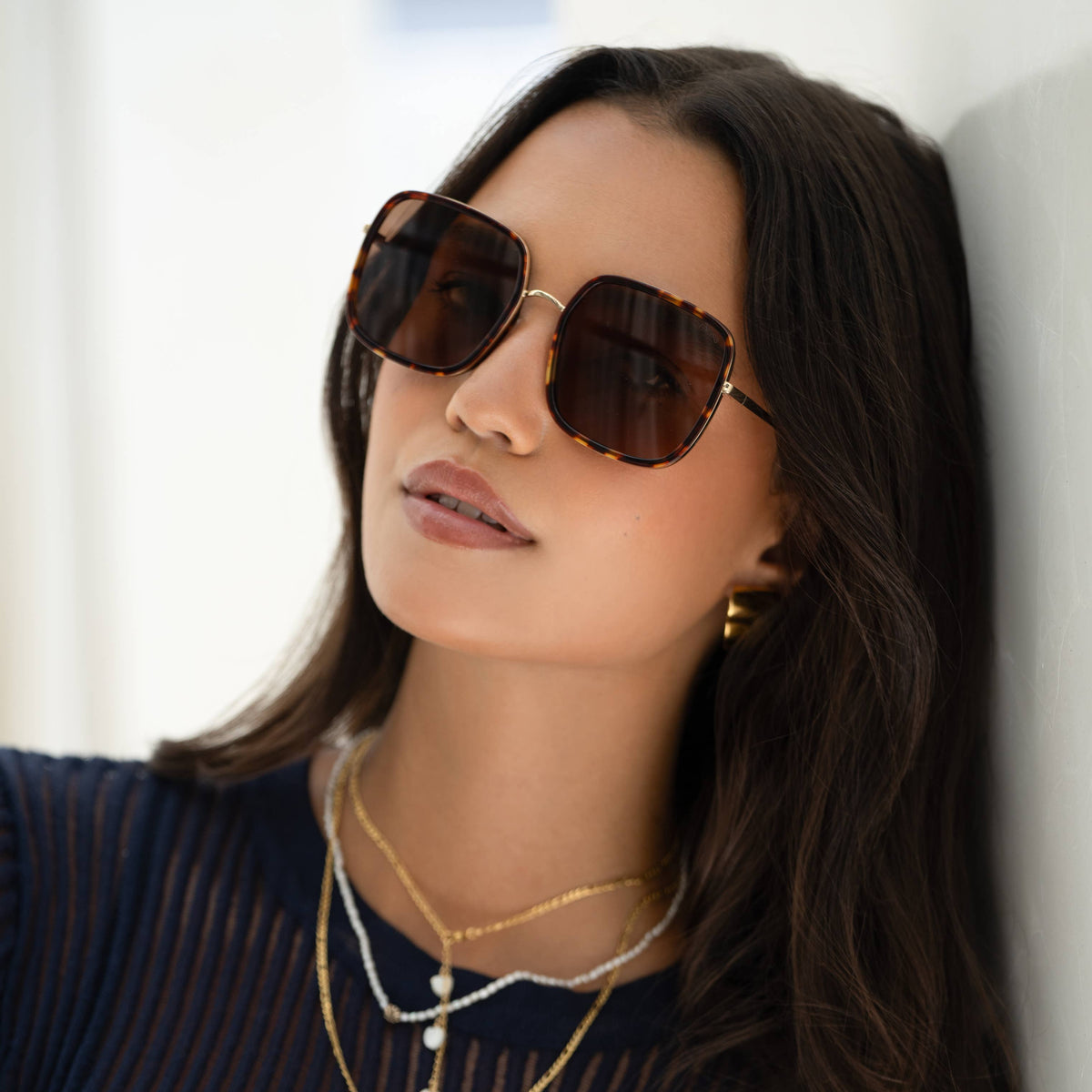 Model wearing Cosmo Acetate Sunglasses with tortoiseshell square frames and brown lenses.