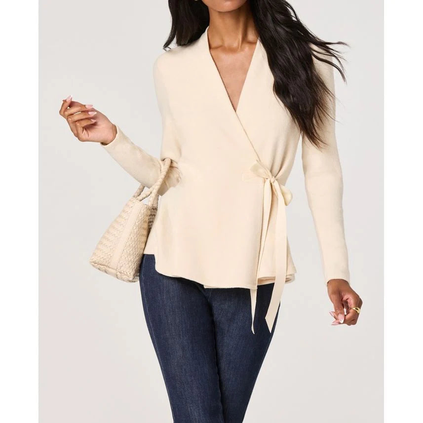 Close-up front view of the Dayna cream knit wrap top with a V-neckline and waist tie closure