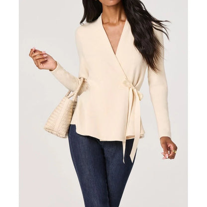 Close-up front view of the Dayna cream knit wrap top with a V-neckline and waist tie closure