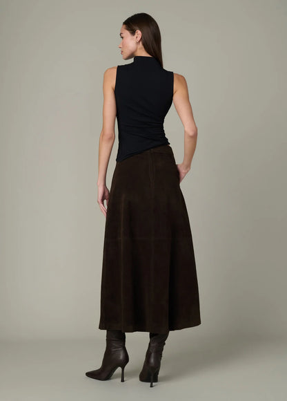 Full-length back view of the black Dove Top paired with a brown midi skirt and dark boots.