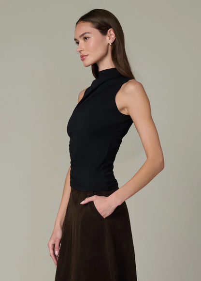 Side profile of the black Dove Top with soft draping and fitted stretch silhouette.