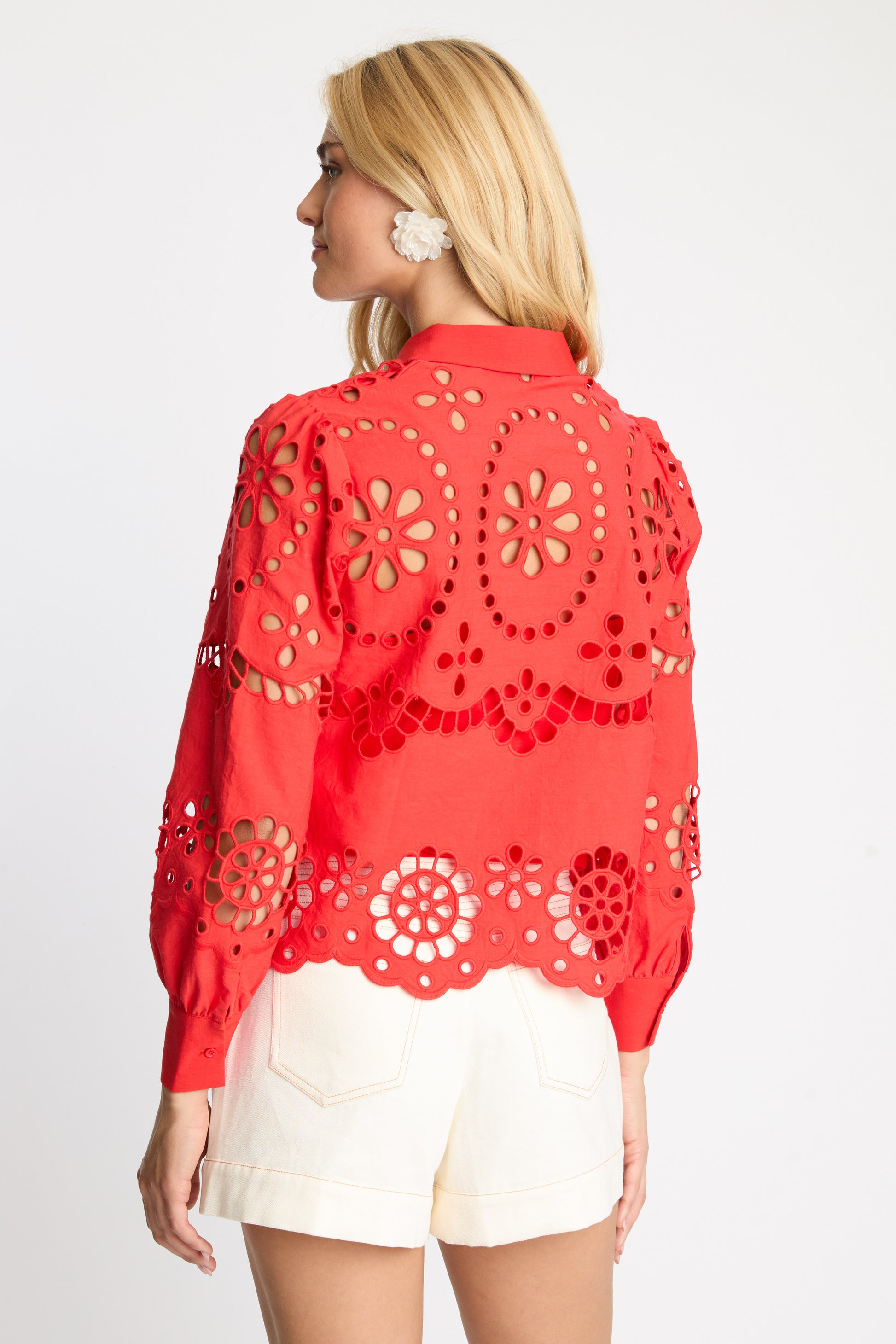 Back view of the Emmie Top in Poppy Red Eyelet Lace featuring floral broderie anglaise embroidery, scalloped hem, and puffed sleeves in a cropped silhouette.