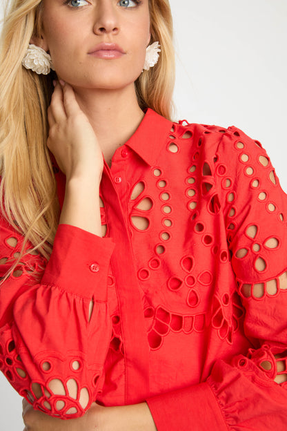Close-up of the Emmie Top in Poppy Red Eyelet Lace showcasing floral eyelet embroidery, puffed sleeves, button-front closure, and scalloped detailing.
