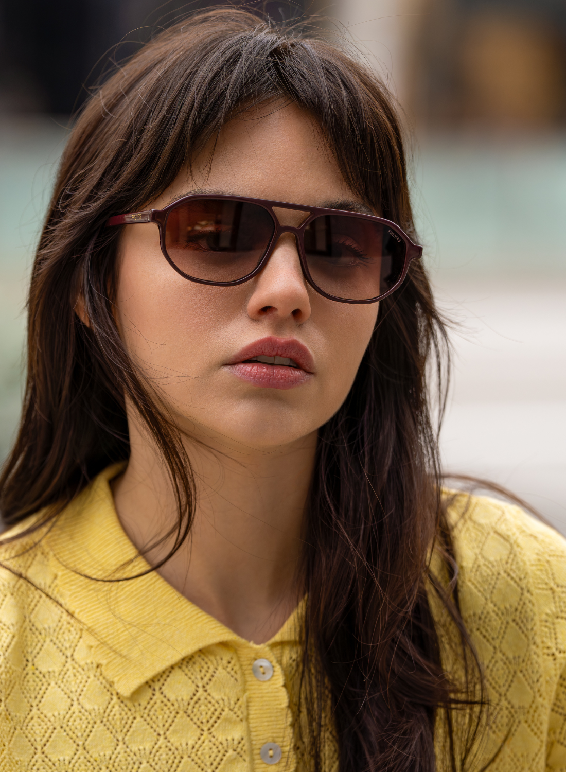 Model wearing Fenix chocolate acetate aviator sunglasses with brown gradient lenses and a yellow textured top.