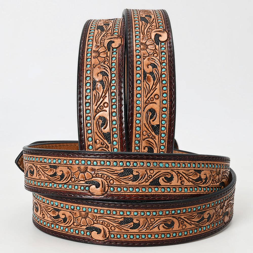 Hand-tooled western leather belt featuring floral scroll embossing, turquoise stud accents, and rich brown leather detailing.