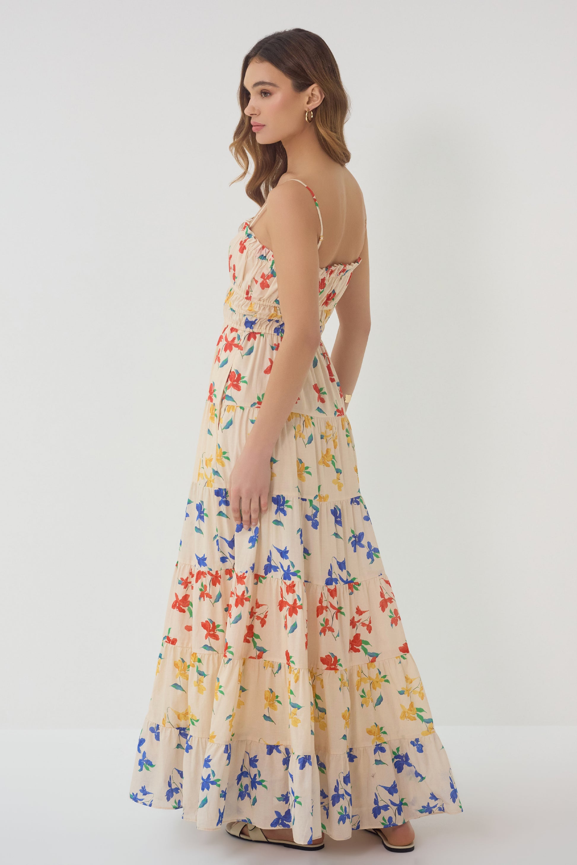 Side view of Flynn Dress showing tiered skirt flow and relaxed silhouette in multicolor floral print