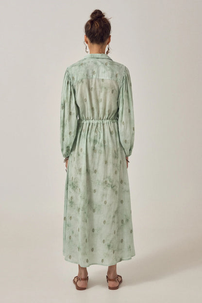 Back view of the Freya Dress in Mineral Waves showing the long relaxed silhouette, elasticated waist, and soft jade tie-dye pattern.