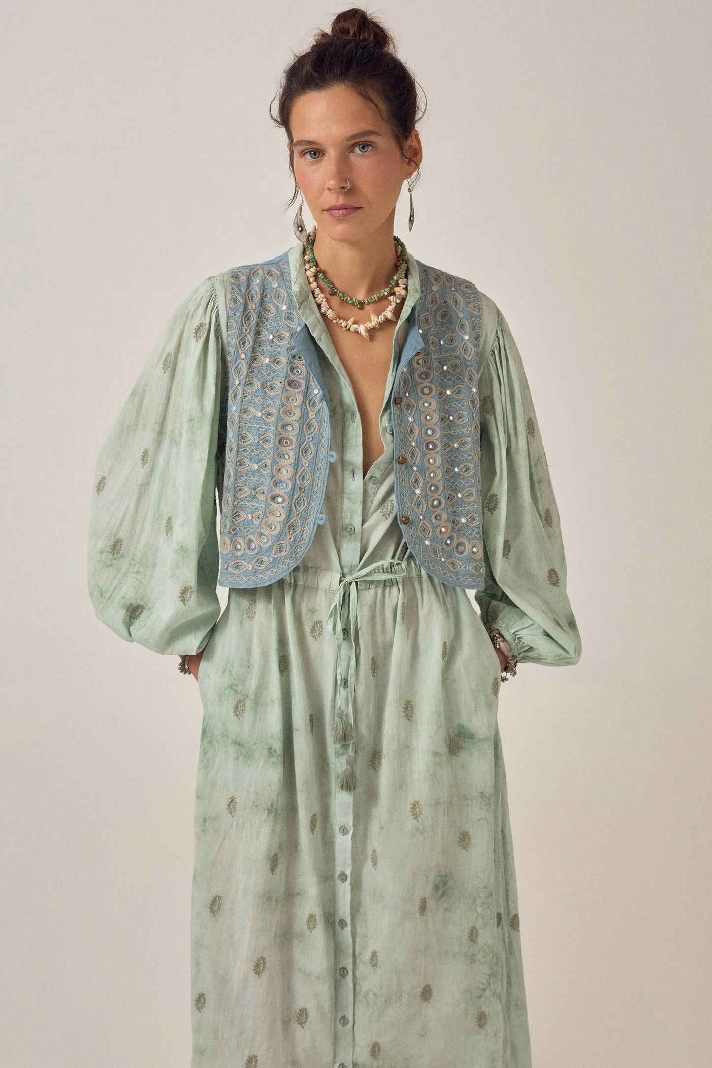 Close-up of the Freya Dress in Mineral Waves featuring a soft jade tie-dye finish, dark green paisley motifs, puff sleeves, and an embroidered cropped vest.