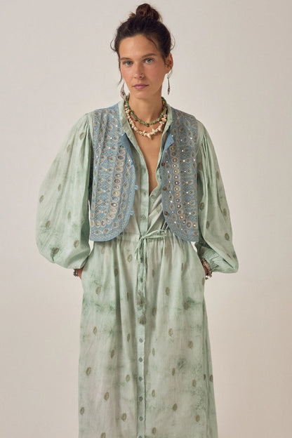 Close-up of the Freya Dress in Mineral Waves featuring a soft jade tie-dye finish, dark green paisley motifs, puff sleeves, and an embroidered cropped vest.