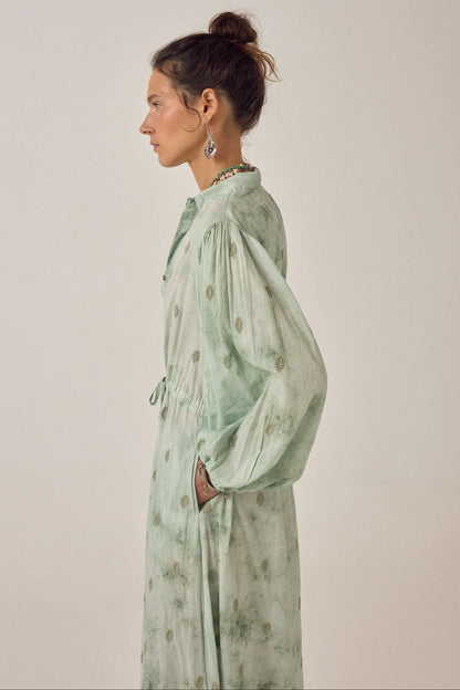 Side profile of the Freya Dress in Mineral Waves featuring a flowing jade tie-dye finish, gathered sleeves, and relaxed cotton voile silhouette.