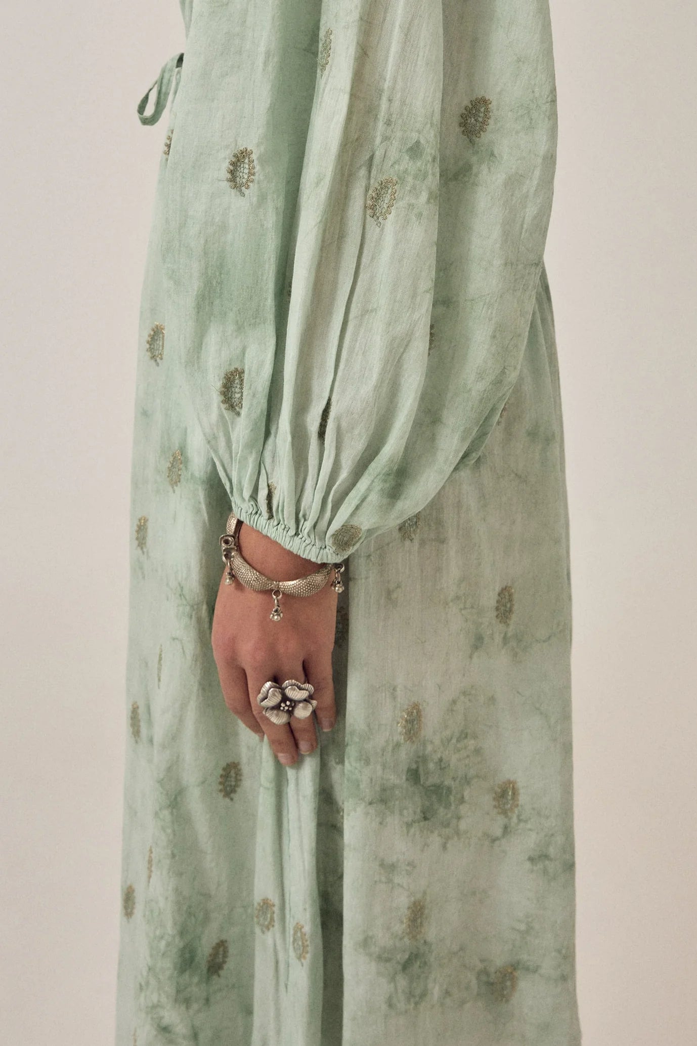 Close-up detail of the Freya Dress in Mineral Waves highlighting the voluminous gathered sleeve, soft tie-dye texture, and delicate paisley motifs.