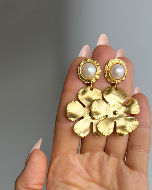 Full Bloom freshwater pearl earrings with 8mm pearls and sculptural 24k gold-filled floral drops held in hand.