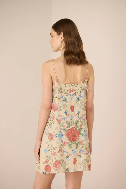Back view of the Gili Mini Dress with adjustable tie-up straps and floral placement print