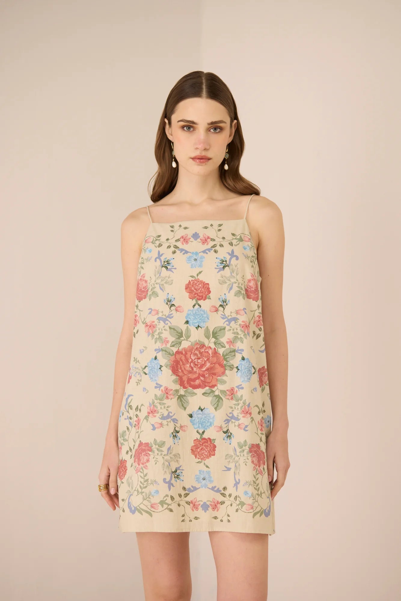 Model wearing the Gili Mini Dress in a floral placement print with tie-up straps.
