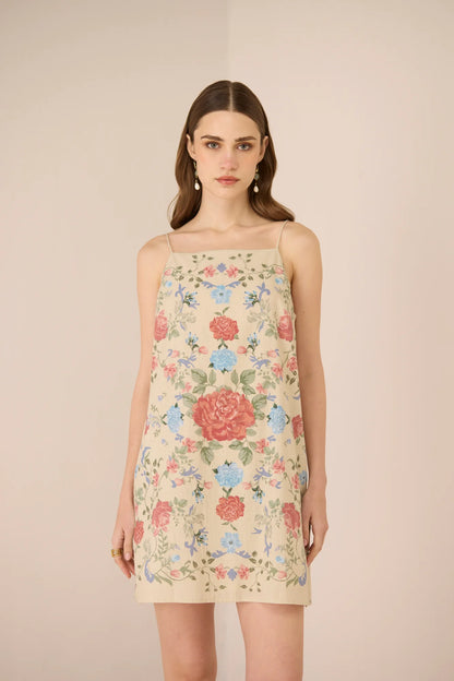 Model wearing the Gili Mini Dress in a floral placement print with tie-up straps.