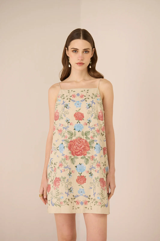 Model wearing the Gili Mini Dress in a floral placement print with tie-up straps.