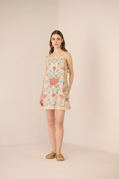 Full-length view of the Gili Mini Dress styled with flat sandals.
