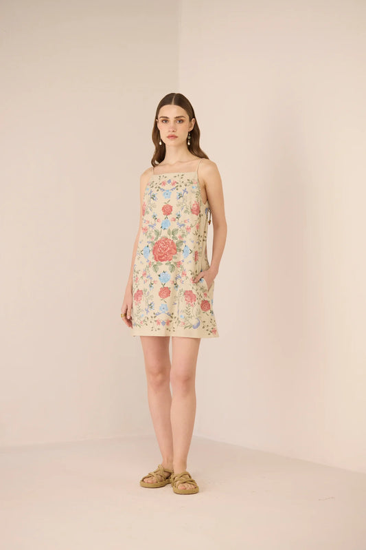 Full-length view of the Gili Mini Dress styled with flat sandals.
