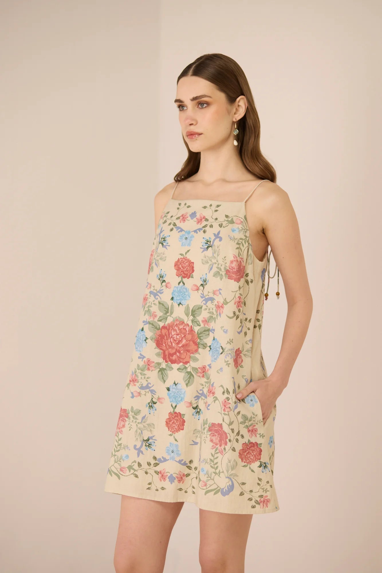 Side view of the Gili Mini Dress showing the mini silhouette and floral print.