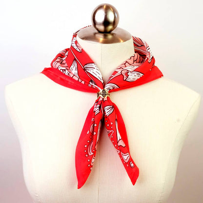 Gladys Brass Bandana Slide Ring styled on a red bandana around a mannequin neck.
