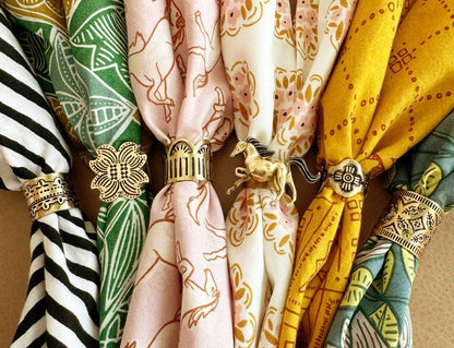 Gladys Brass Bandana Slide Rings styled with a collection of colorful patterned bandanas.
