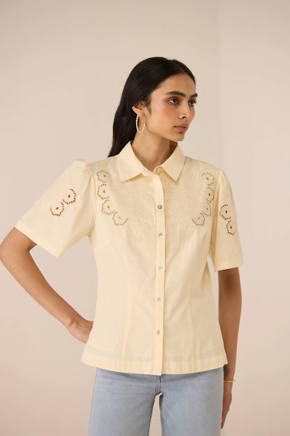 Angled front view of the Hartley Shirt, highlighting the cream cotton poplin fabric and embroidered sleeve detail.