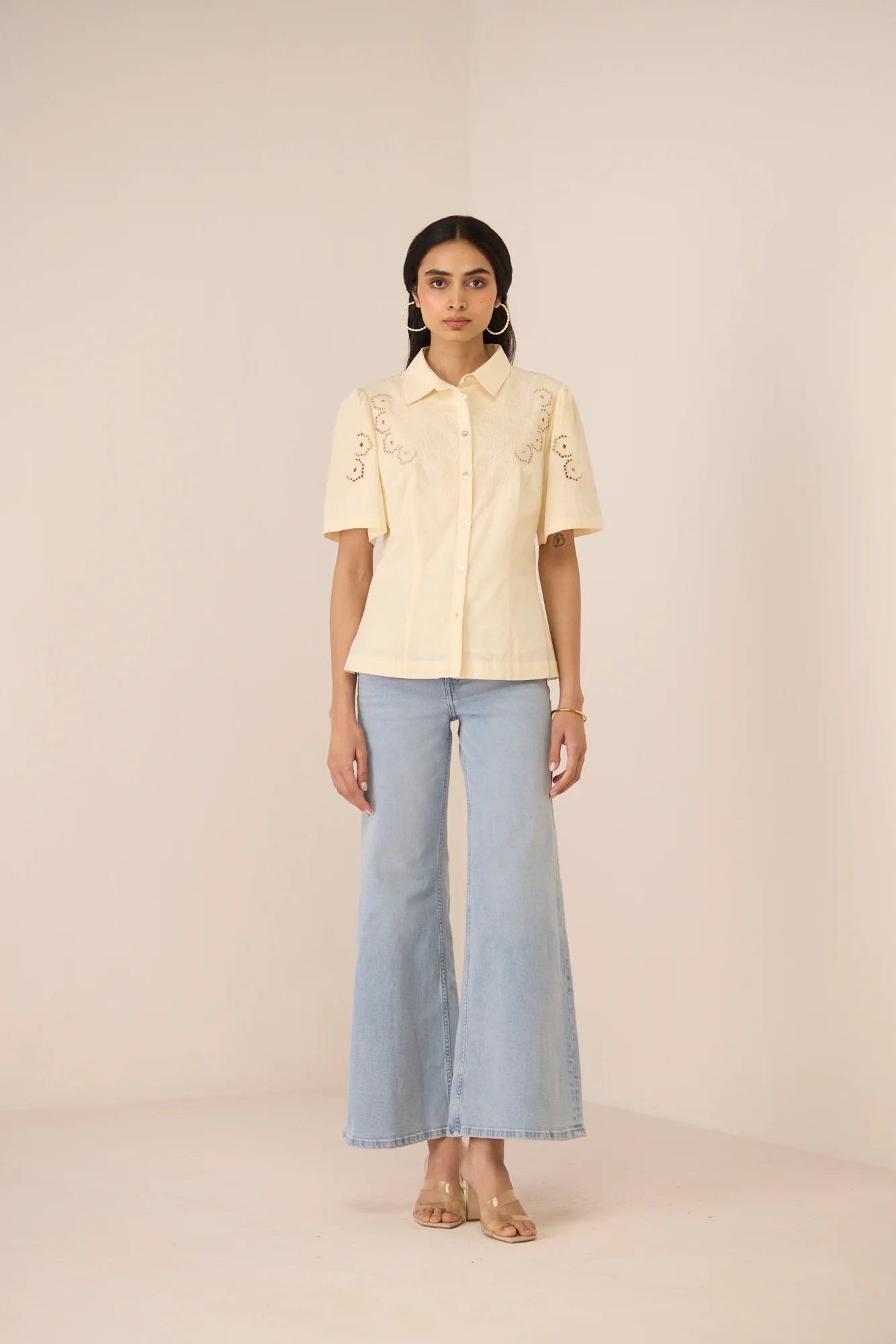 Hartley Shirt in cream cotton poplin with botanical embroidery, shown from the front with light blue jeans.