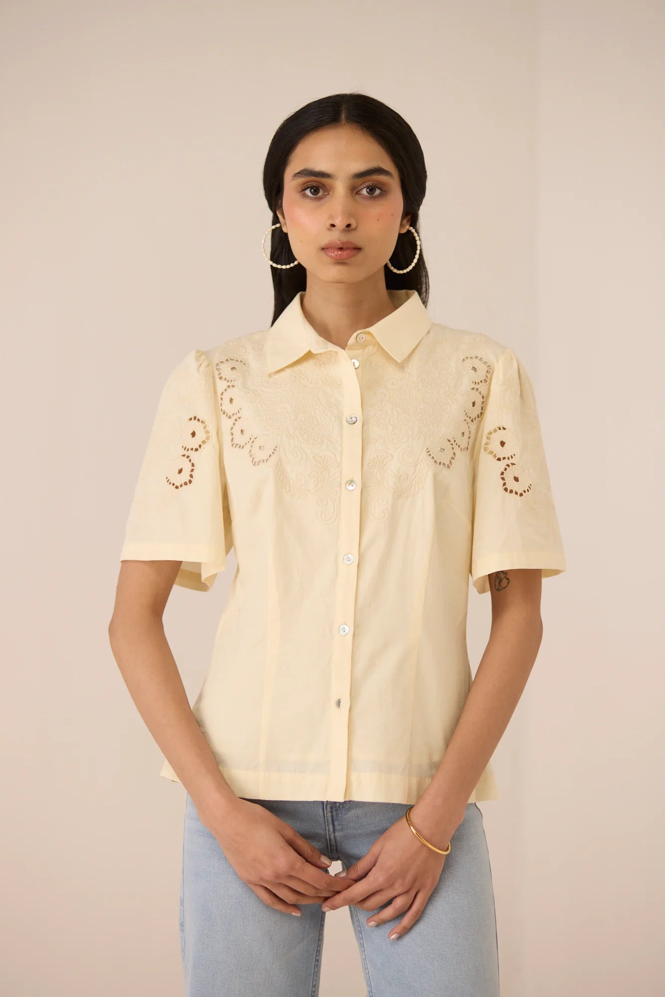 Hartley Shirt styled with light blue jeans, featuring botanical embroidery on the yoke and sleeves.