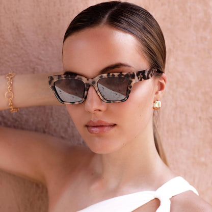 Model wearing Hayden rectangular sunglasses in Milky Tortoise with brown lenses, highlighting the structured acetate frame and modern unisex silhouette.