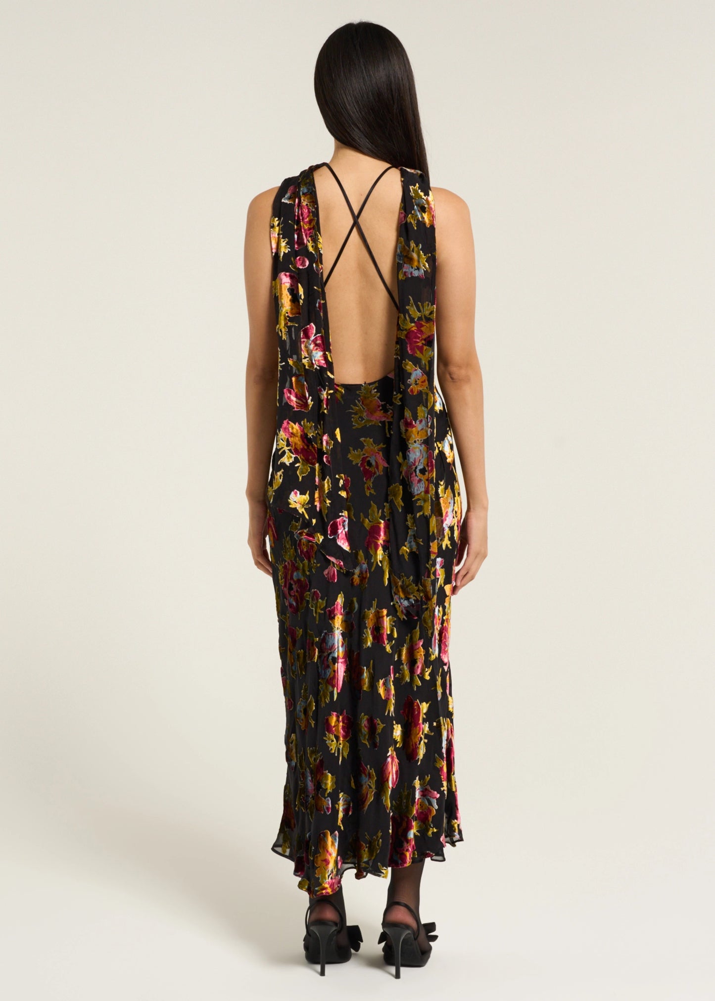 Back view of the Hayley Dress in Countryside Devoré Black with an open back design, delicate cross straps, and flowing floral devoré fabric.
