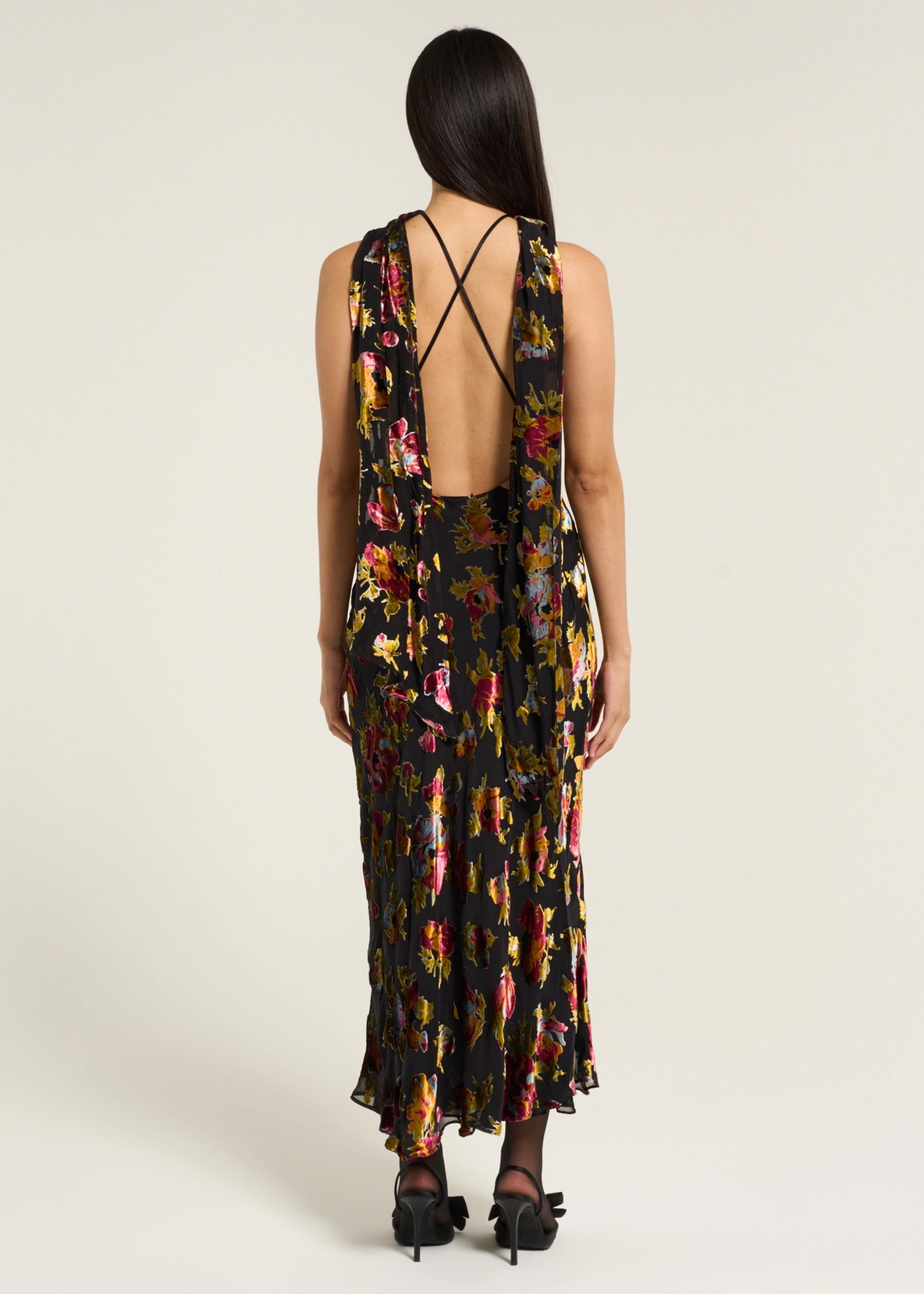 Back view of the Hayley Dress in Countryside Devoré Black with an open back design, delicate cross straps, and flowing floral devoré fabric.