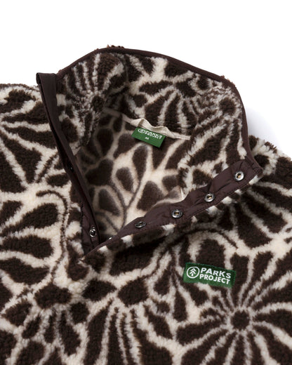 Close-up of the High Desert Wildflowers fleece showing the high collar, snap placket, floral pattern, and plush texture.