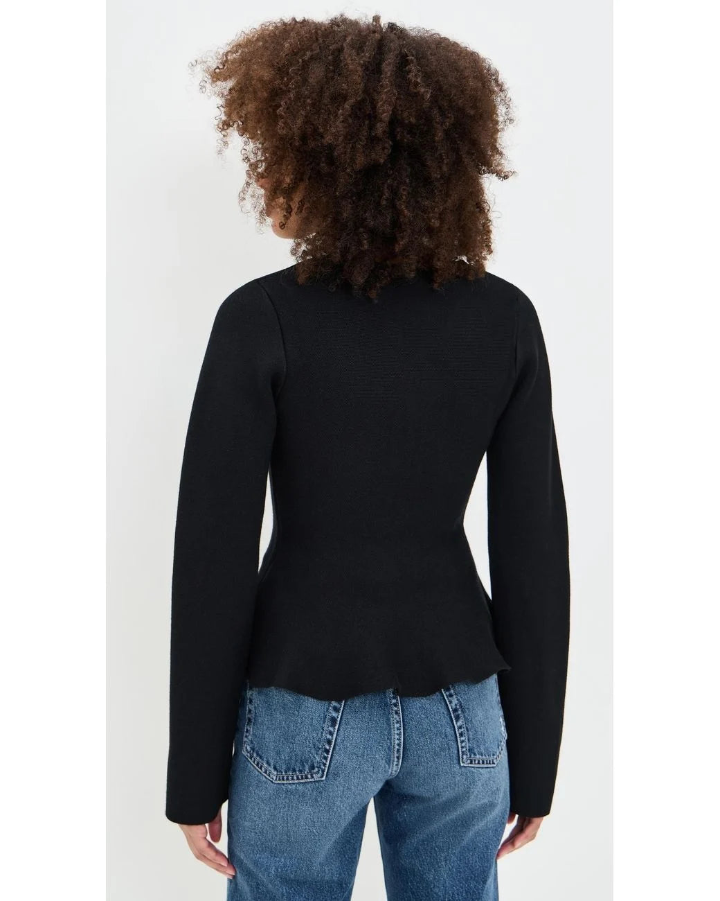 Back view of the black Idah Cardigan featuring a fitted peplum silhouette and long sleeves.