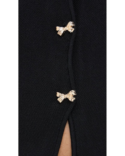 Close-up detail of the Idah Cardigan featuring gold-tone bow front buttons on black knit fabric.