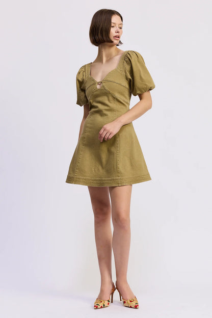 Side front view of the Isabelle Mini Dress in olive green featuring a structured bodice, subtle front cut-out, puff sleeves, and feminine A-line shape.