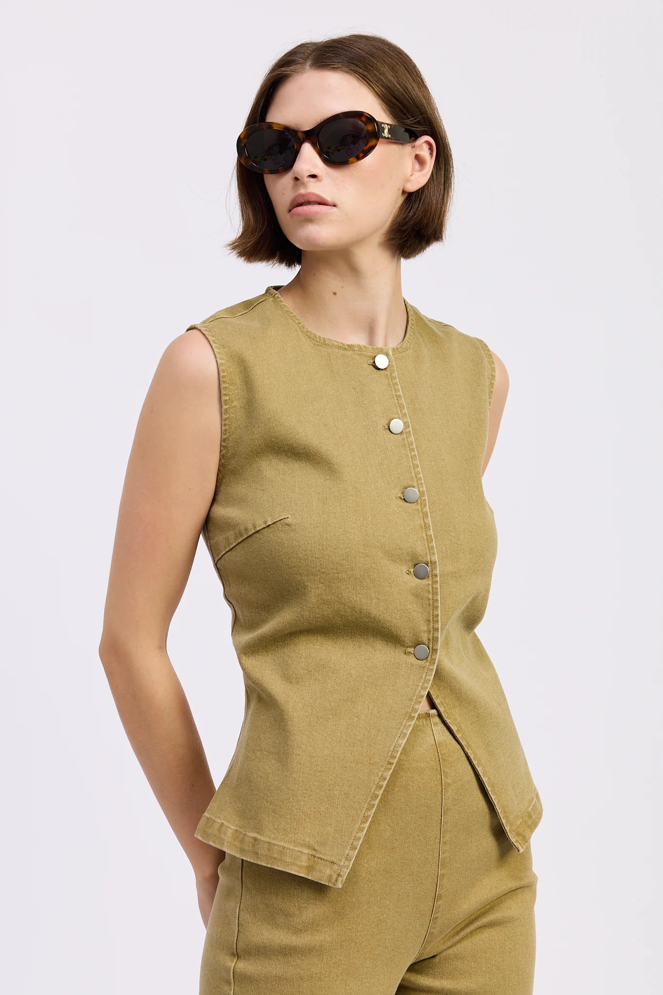 Close-up of the olive Isabelle Vest Top featuring a structured sleeveless silhouette and button-through front.