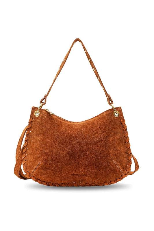Joëlle camel suede handbag with a curved silhouette, studded handle, piping trim, and removable shoulder strap.