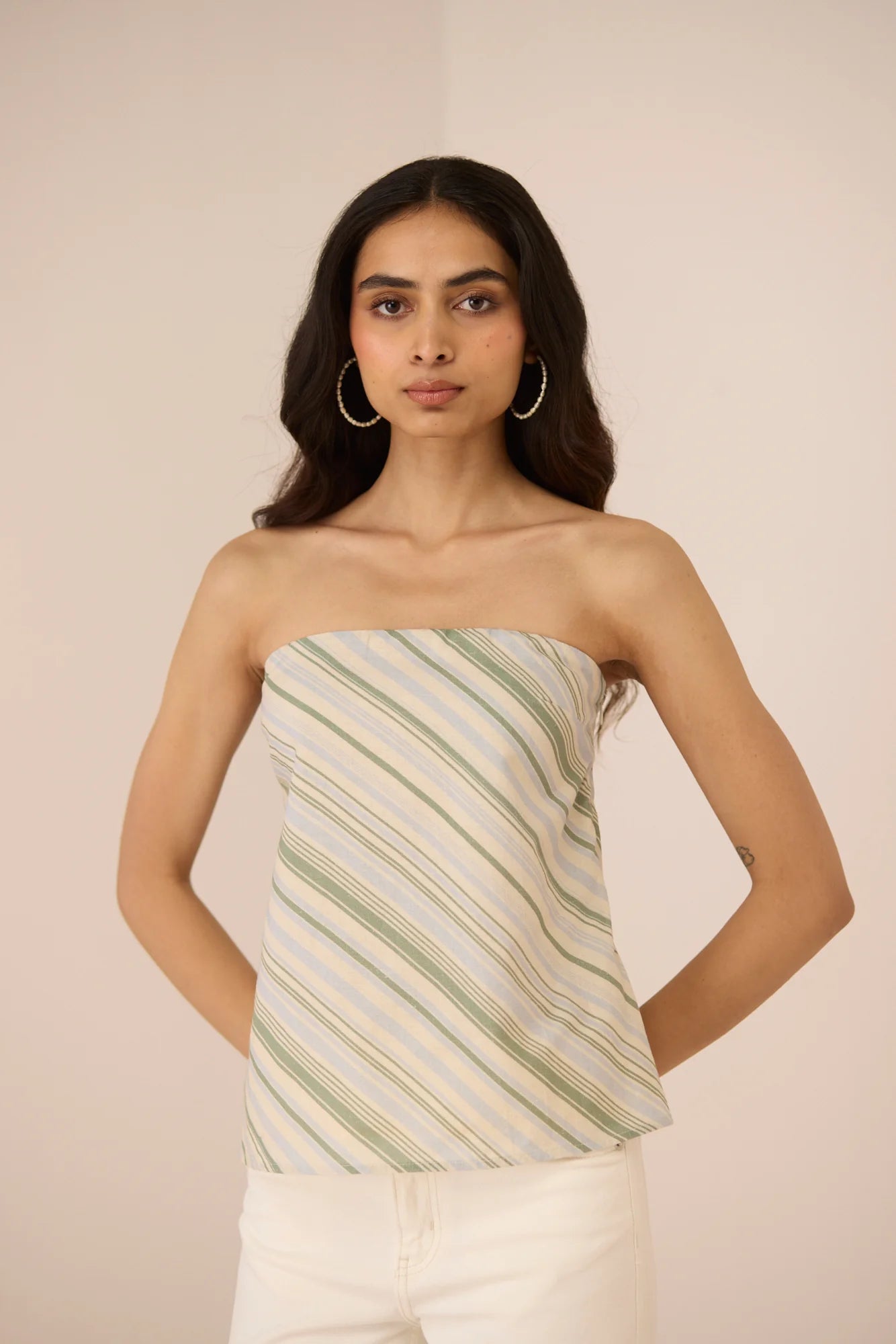 Front detail of the Josie Diagonal Stripe Tube Top, a strapless cotton linen top with cream and green diagonal stripes.