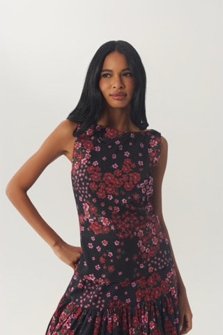 Model wearing the fitted floral Kady Top in Black/Rose with one hand at the waist.