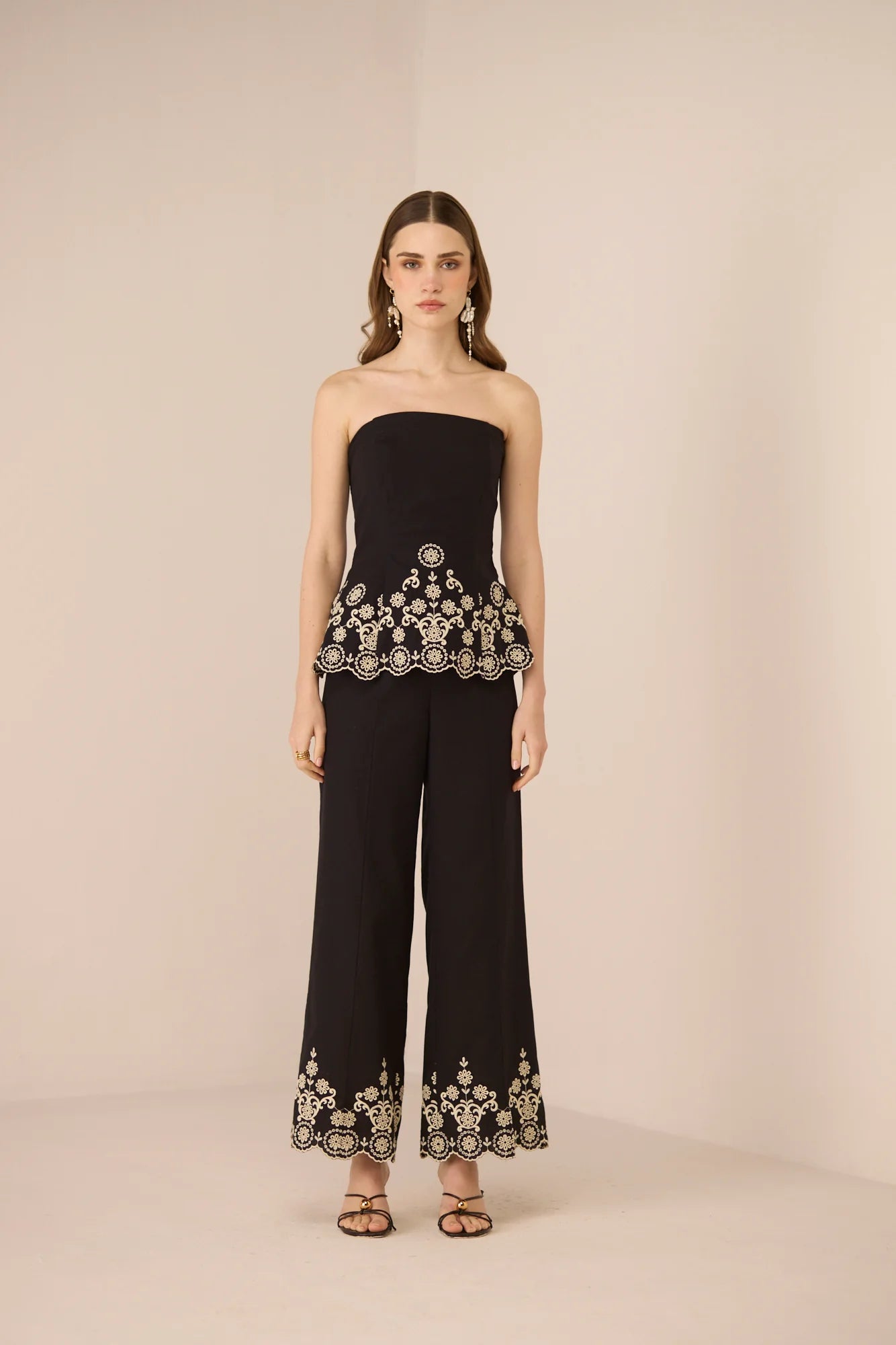 Kaia Tube Top in black styled with matching black trousers for a coordinated evening look.