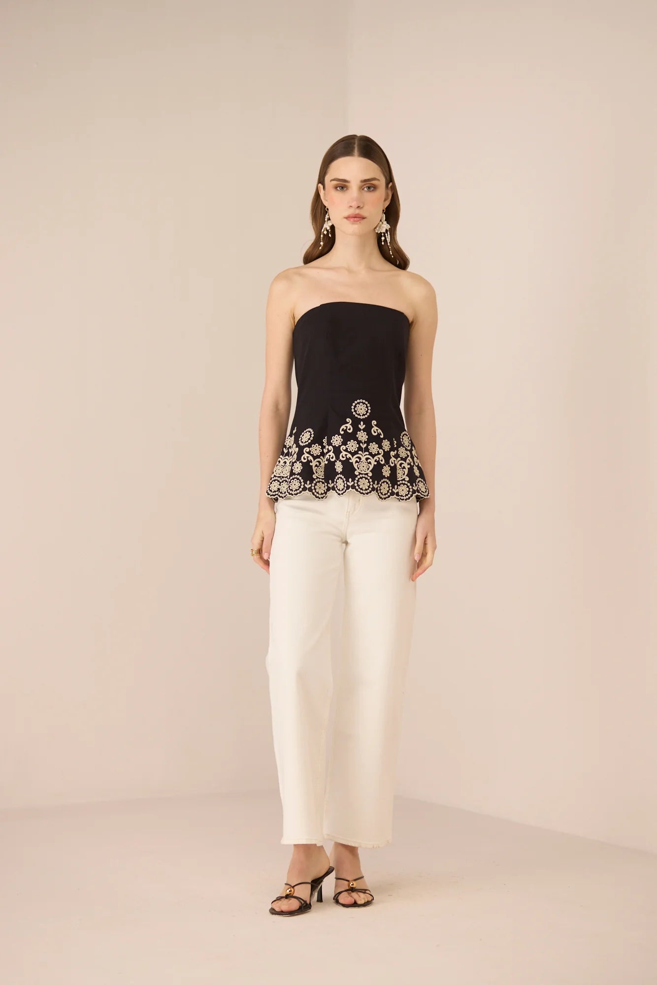 Kaia Tube Top in black styled with white trousers for a polished day-to-evening look.