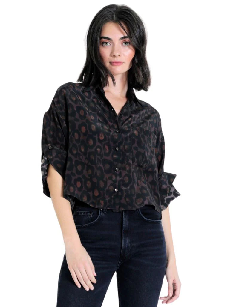Model wearing the Malaga Print Shirt in a black leopard print viscose fabric with rolled tab sleeves and button-down front.