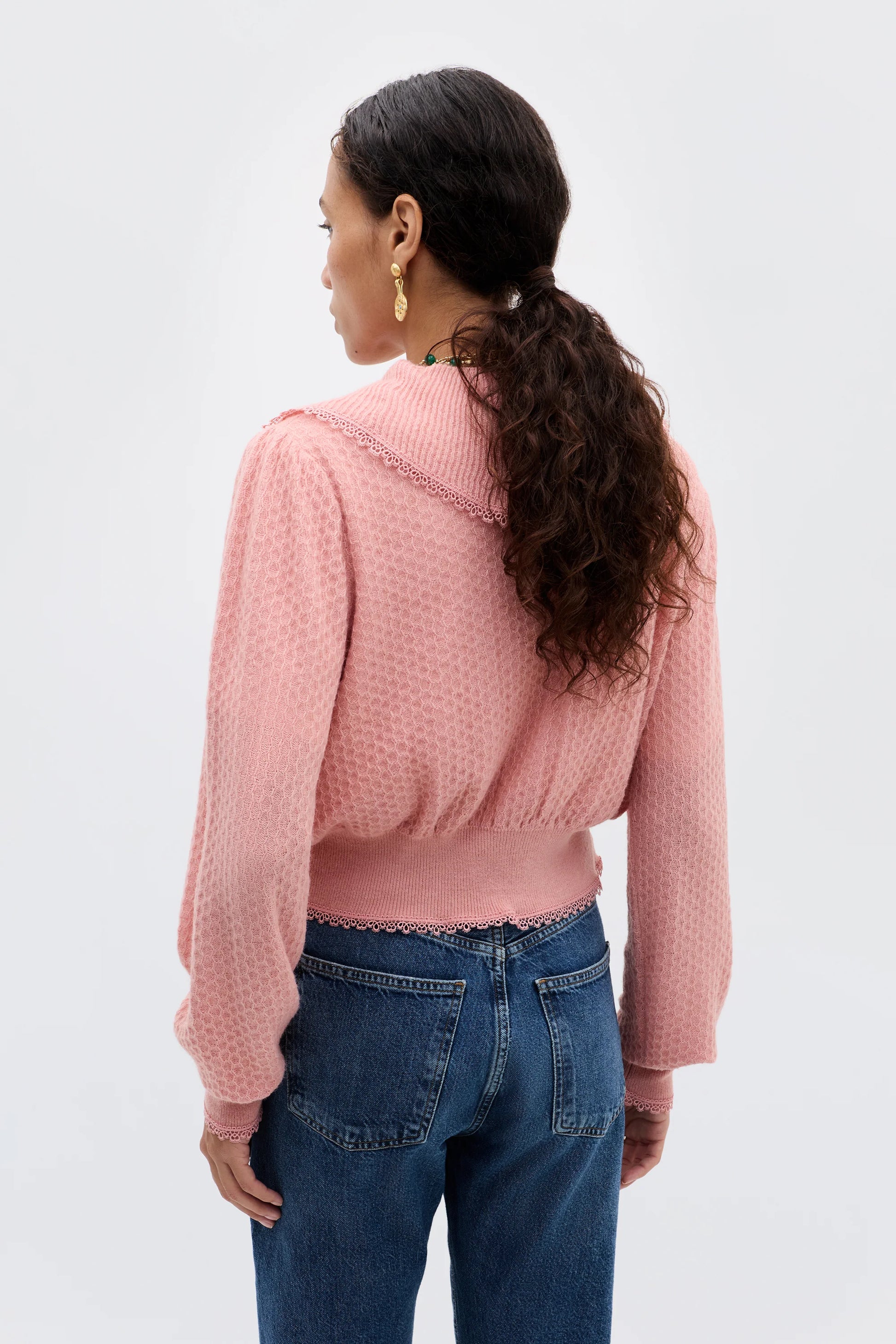 Back view of the Kianna blush cardigan featuring long sleeves, textured lightweight knit fabric, and a soft fitted waistband.