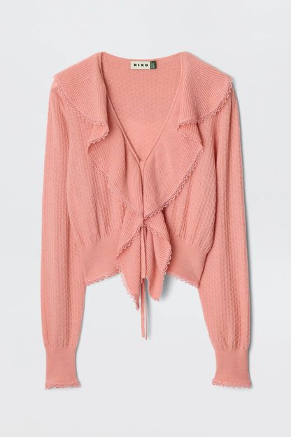 Flat lay image of the Kianna Cardigan in blush with tie-front detail, cascading ruffles, deep V-neckline, and textured knit construction.