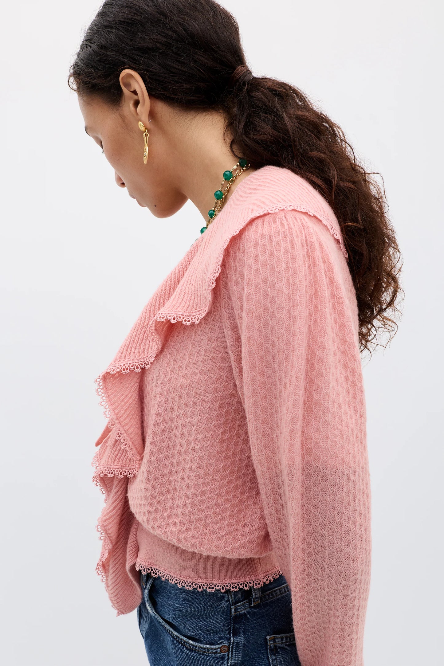 Side profile of the Kianna cardigan in blush highlighting the textured knit fabric, oversized ruffled collar, and relaxed feminine silhouette.