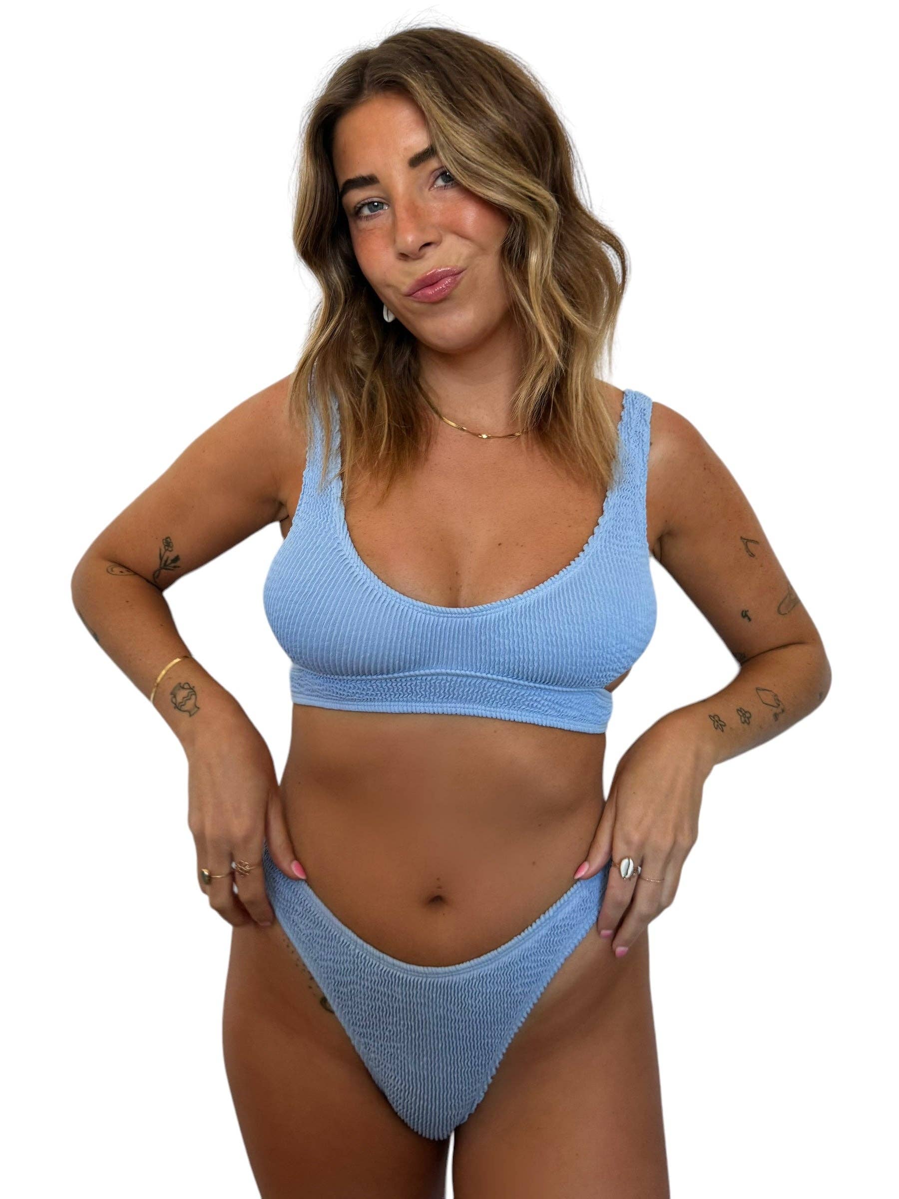 Model wearing the Kiera Top in Orchid, a light blue ribbed swim top with wide straps and matching bikini bottom.